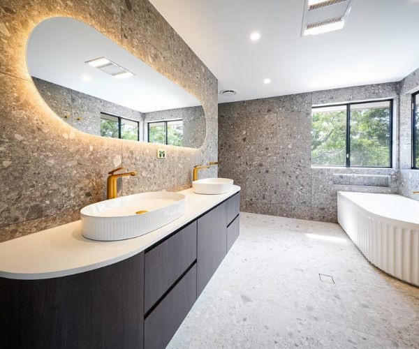 Bathroom renovation featuring new flooring and fixtures